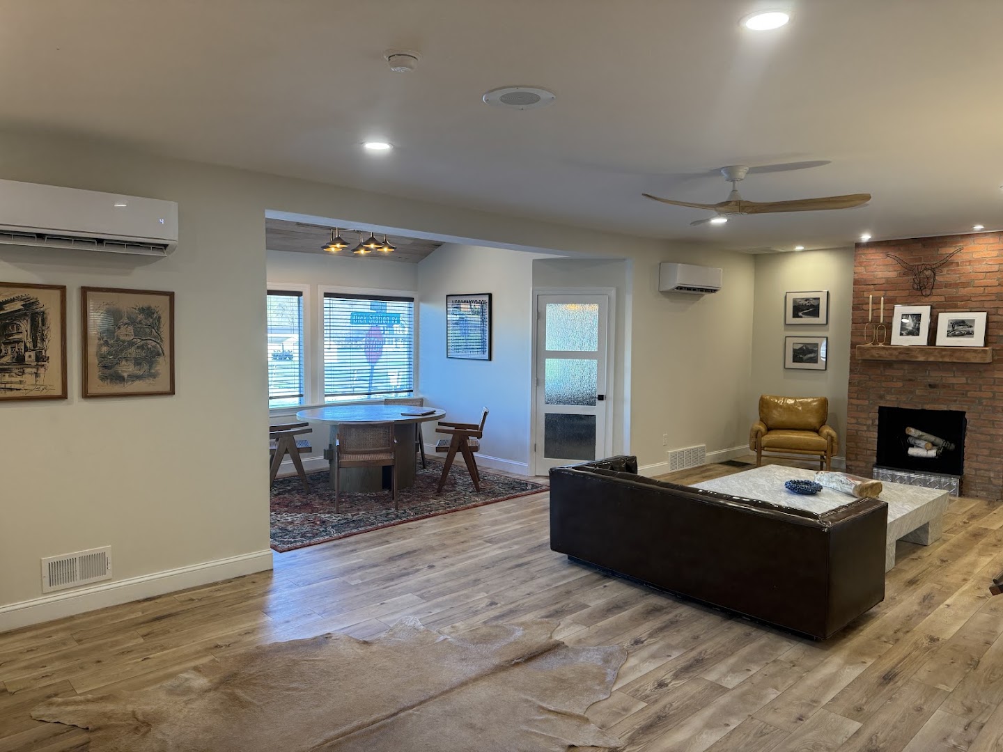 A finished living room with new hardwood-look flooring and finish carpentry details