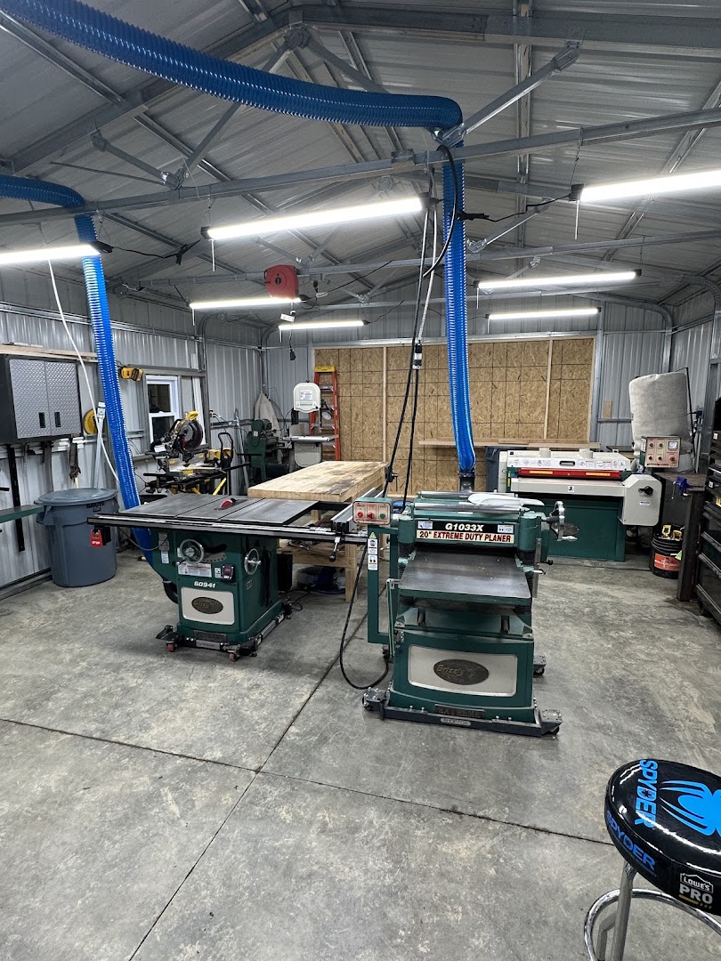 Luke's WoodWorks shop interior showing a table saw, planer, and dust collection system